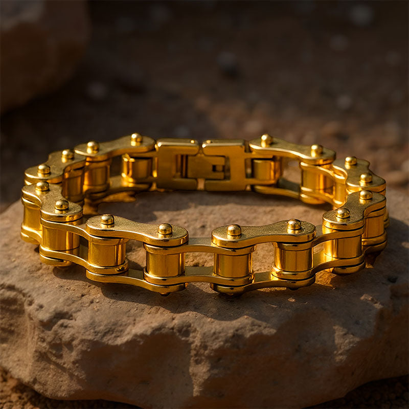 Gold chain bracelet on a textured stone surface