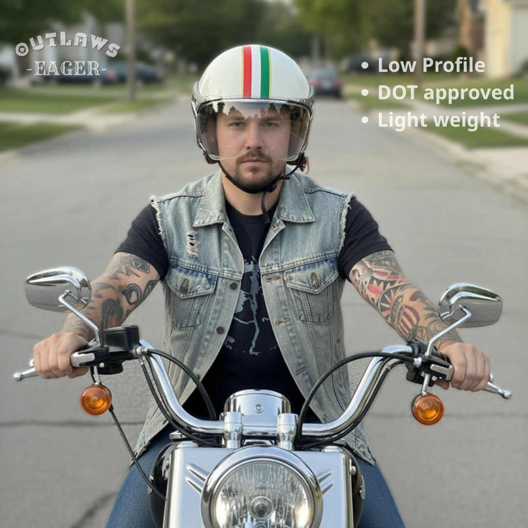 Man riding a motorcycle wearing a helmet with Outlaws Eager branding.