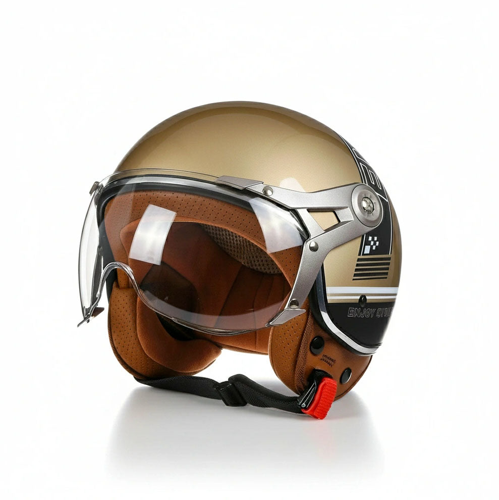 Gold motorcycle helmet with clear visor on a white background