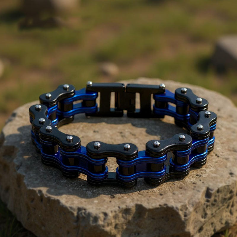 Blue and black chain bracelet on a stone surface with a natural background