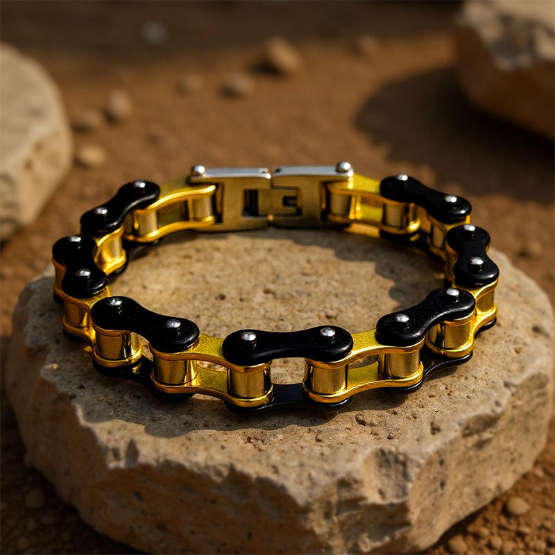 Gold and black chain bracelet on a stone surface