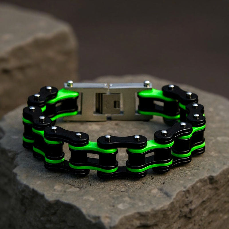 Black and green chain bracelet on a stone surface