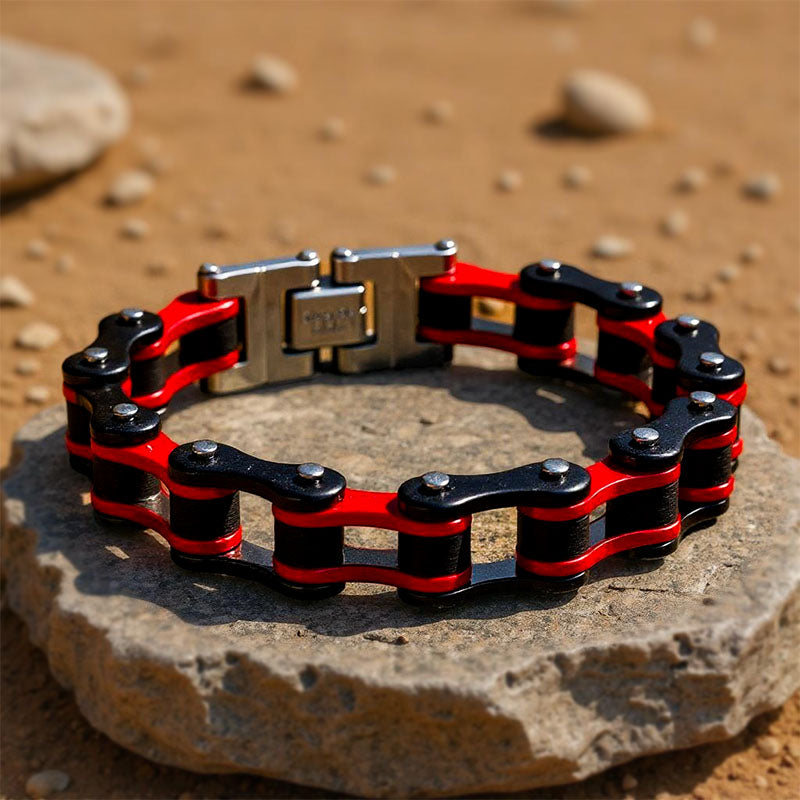 Red and black chain bracelet on a stone surface with a natural background