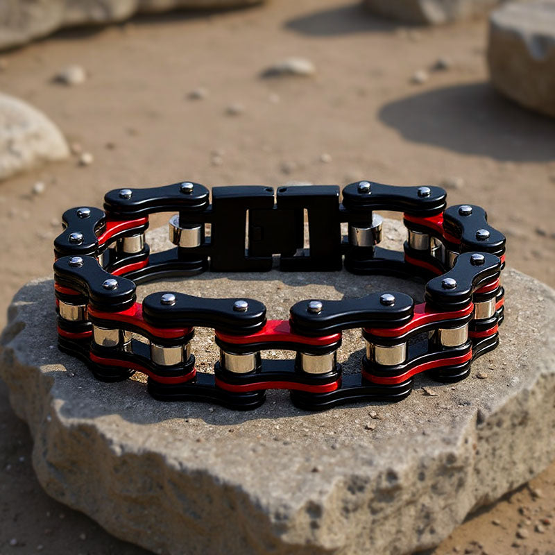 Black and red chain bracelet on a stone surface with a natural background