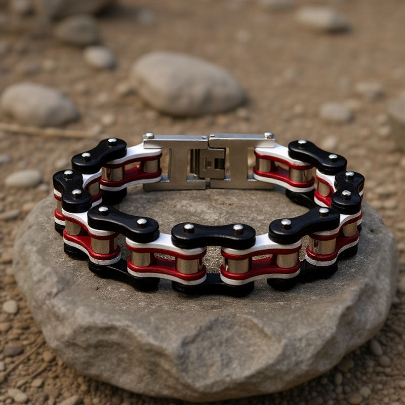 Bracelet with black, red, and white design on a rock