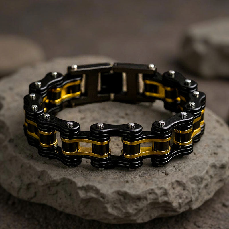Black and gold chain bracelet on a stone surface
