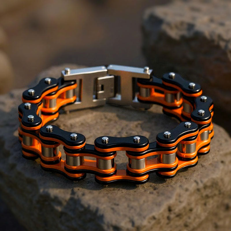 Orange and black chain bracelet on a stone surface