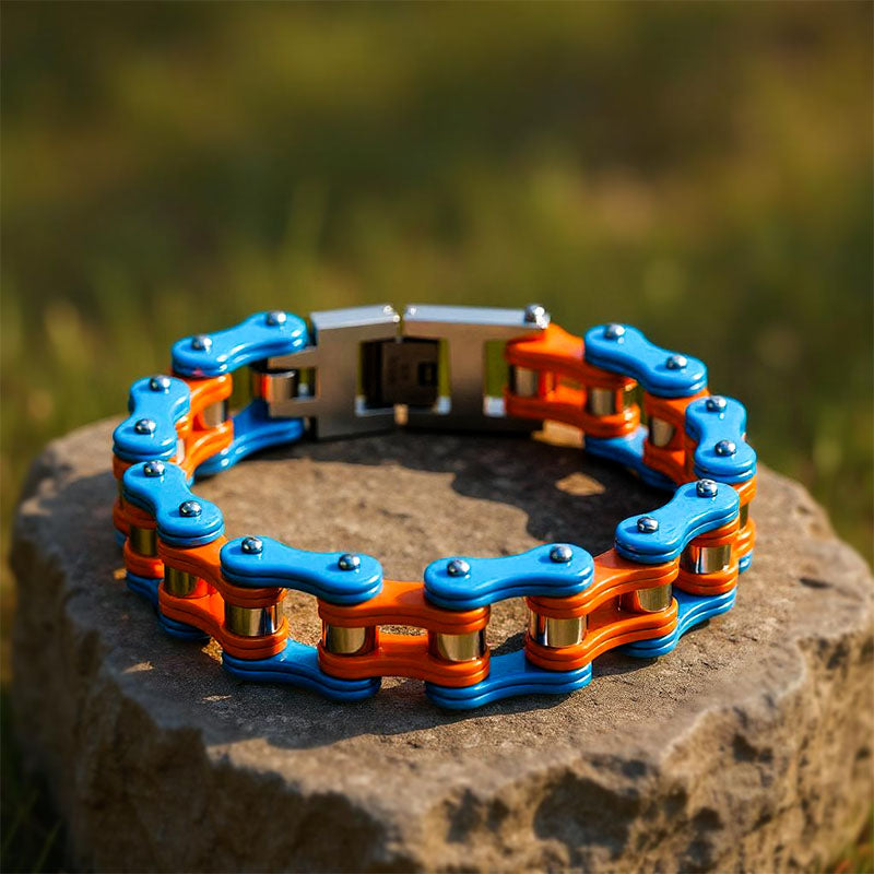 Blue and orange chain bracelet on a stone surface with a blurred natural background