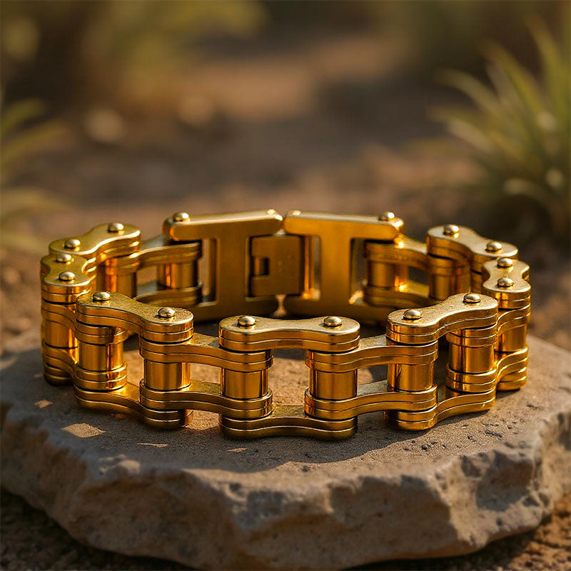 Gold chain bracelet on a stone surface with a blurred natural background