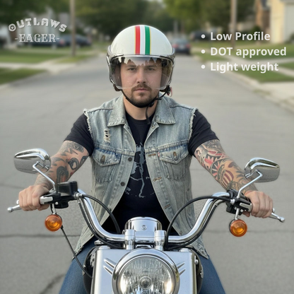 Man riding a motorcycle wearing a helmet with Outlaws Eager branding.