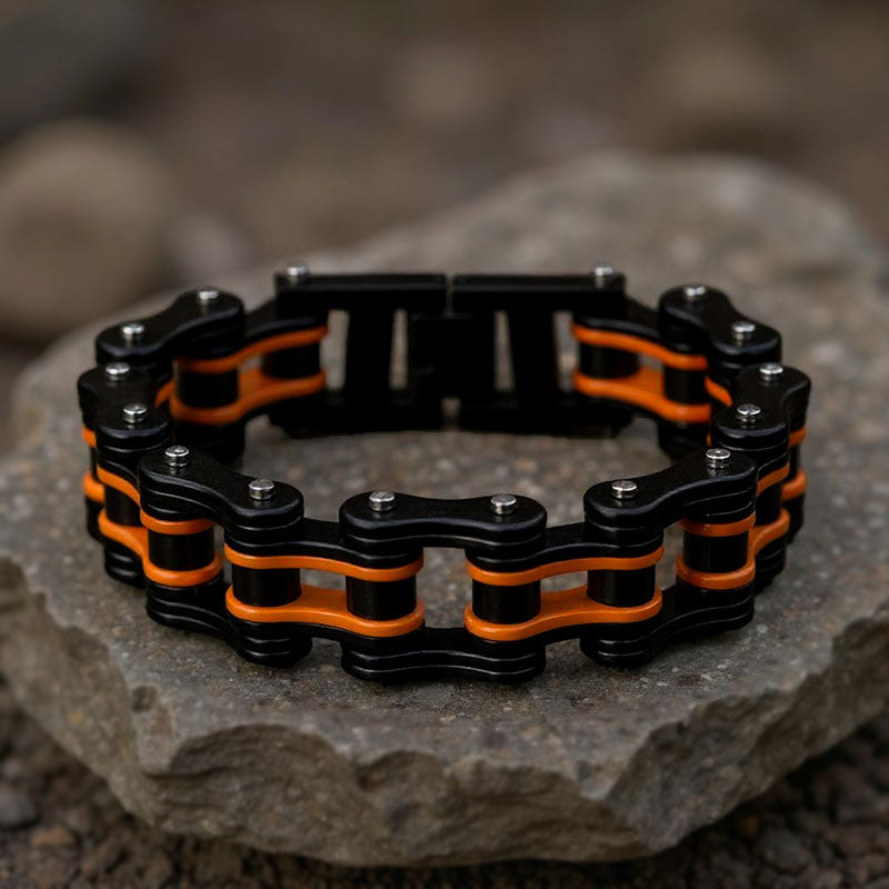 Black and orange chain bracelet on a stone surface