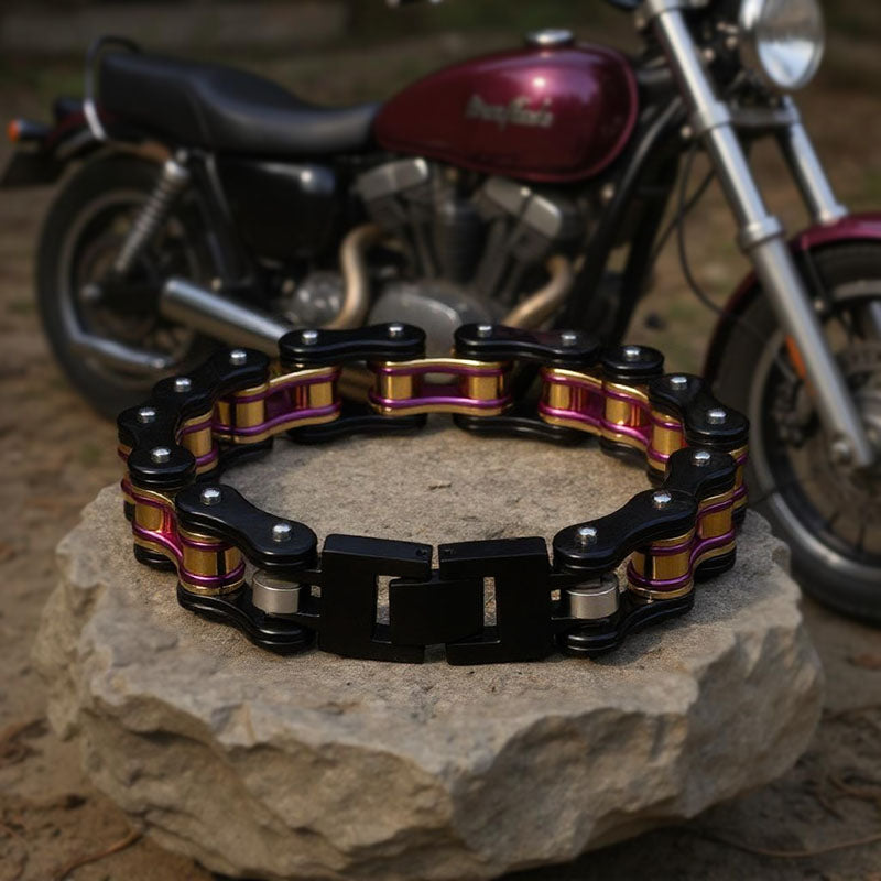 Bracelet made from a motorcycle chain on a rock with a motorcycle in the background