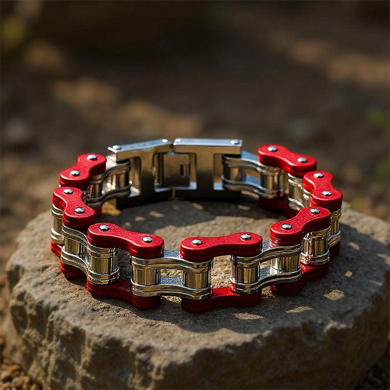 Red and silver chain bracelet on a stone surface