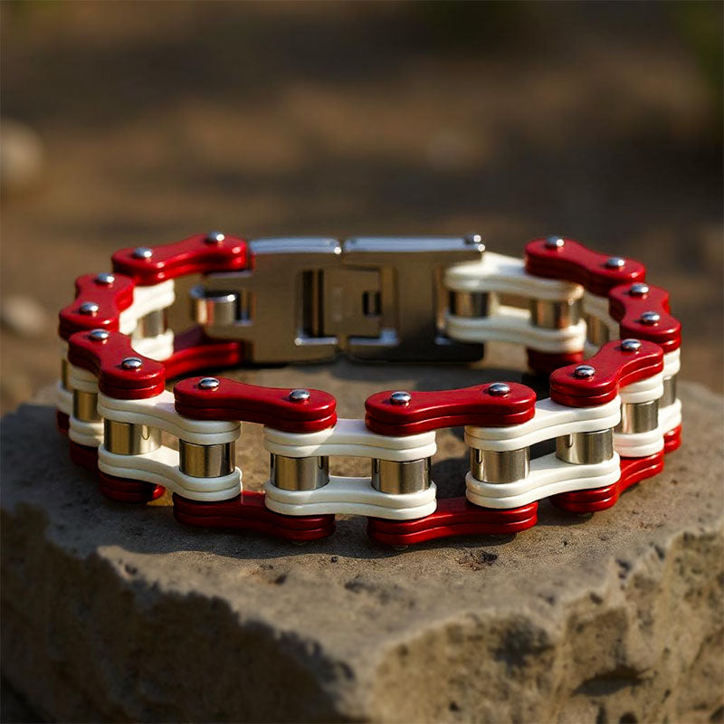 Red and white chain bracelet on a stone surface with a blurred natural background