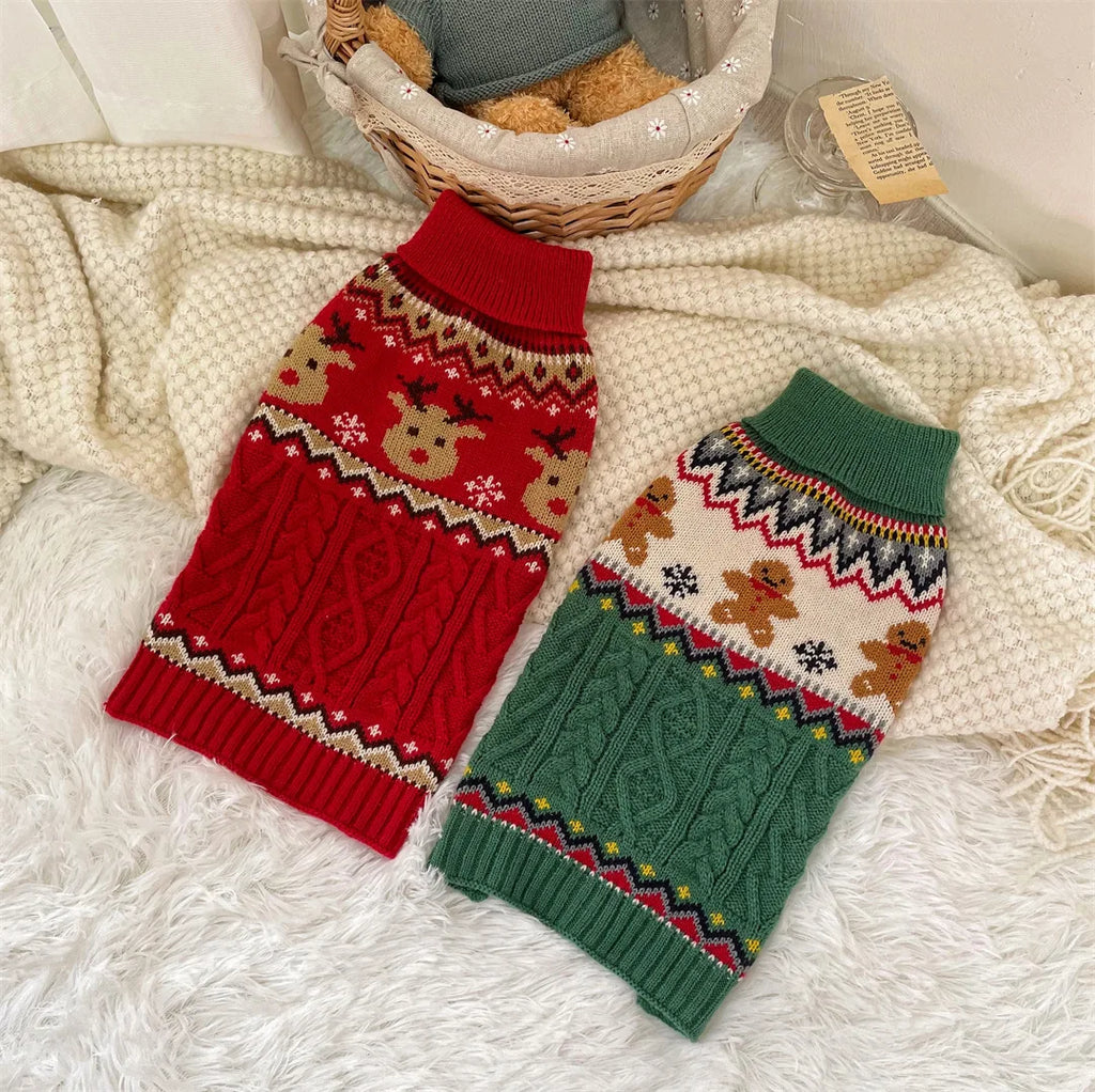 Two dog sweaters, one red and one green, with festive patterns on a textured surface.