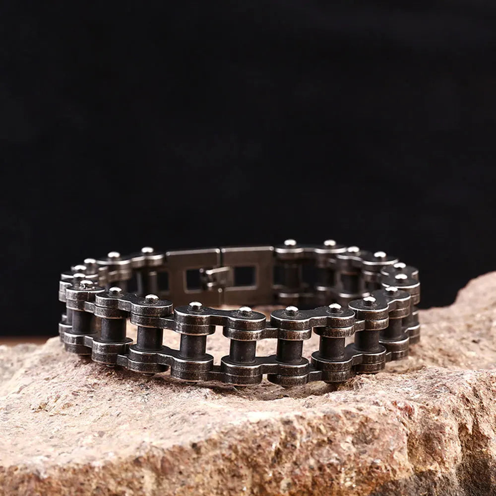 Metal chain bracelet on a stone surface with a dark background