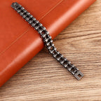 Metallic watch strap on a brown leather surface