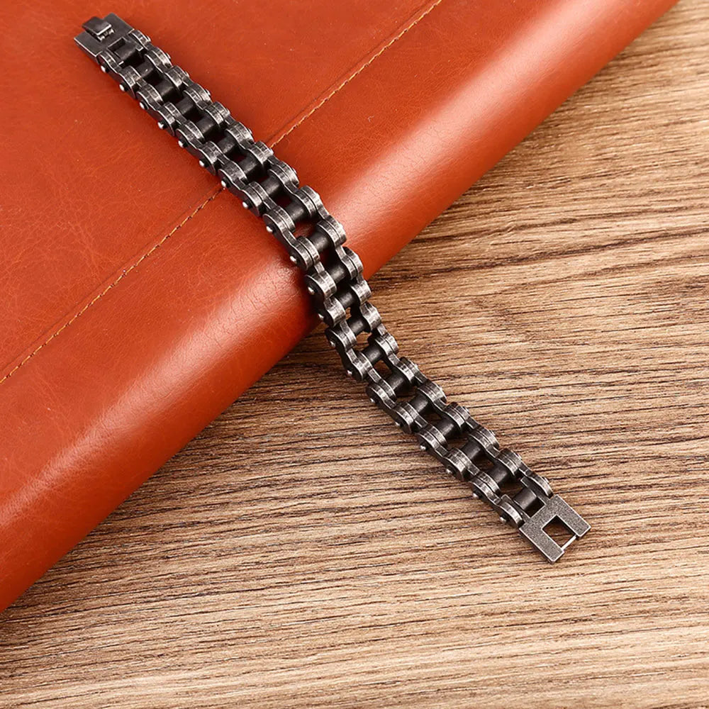 Metallic watch strap on a brown leather surface