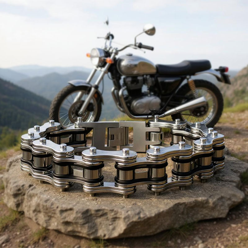 Motorcycle chain bracelet on a rock with a motorcycle in the background