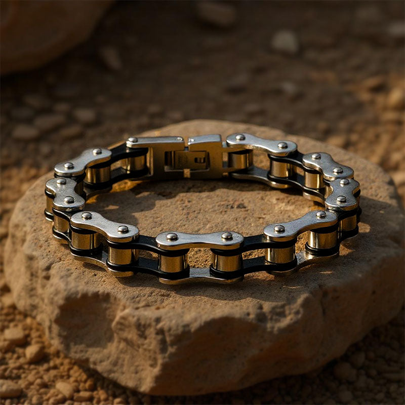 Bracelet made of interlocking metal links on a stone surface