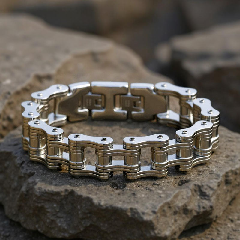 Metallic chain bracelet on a textured stone surface